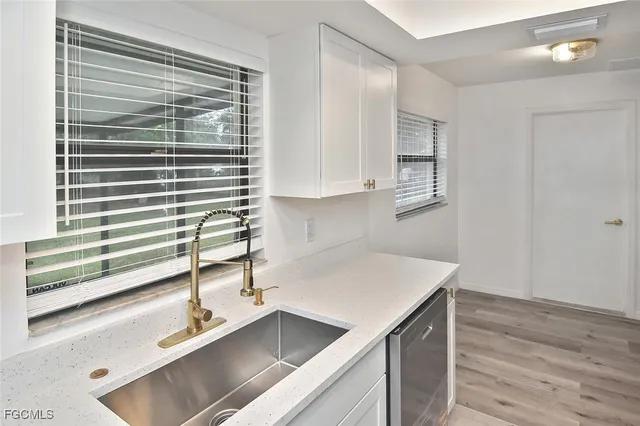 a kitchen with a sink and a window
