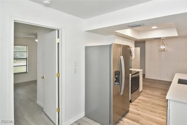 a view of a refrigerator in kitchen and wooden floor