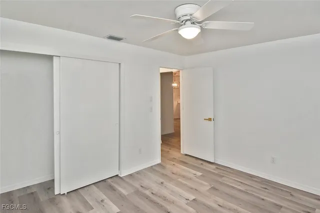 an empty room with fan and a ceiling fan