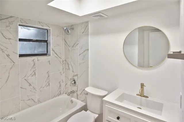 a bathroom with a toilet sink and bathtub
