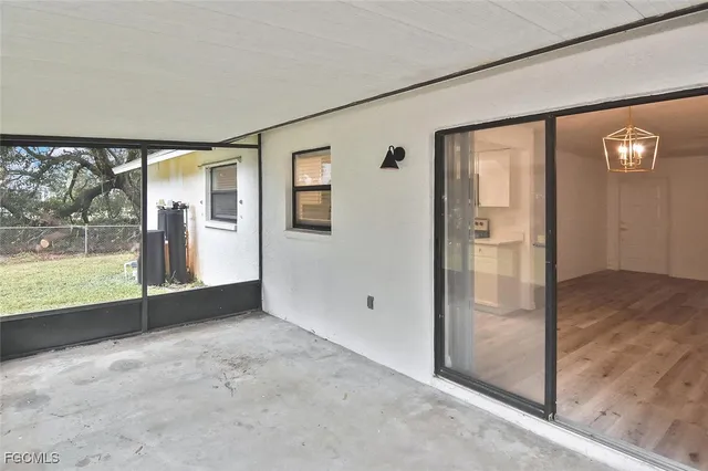 an empty room with windows and entrance