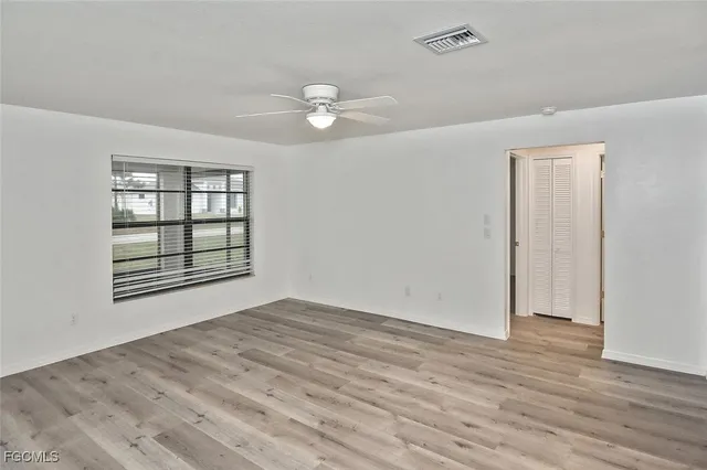wooden floor in an empty room with a window