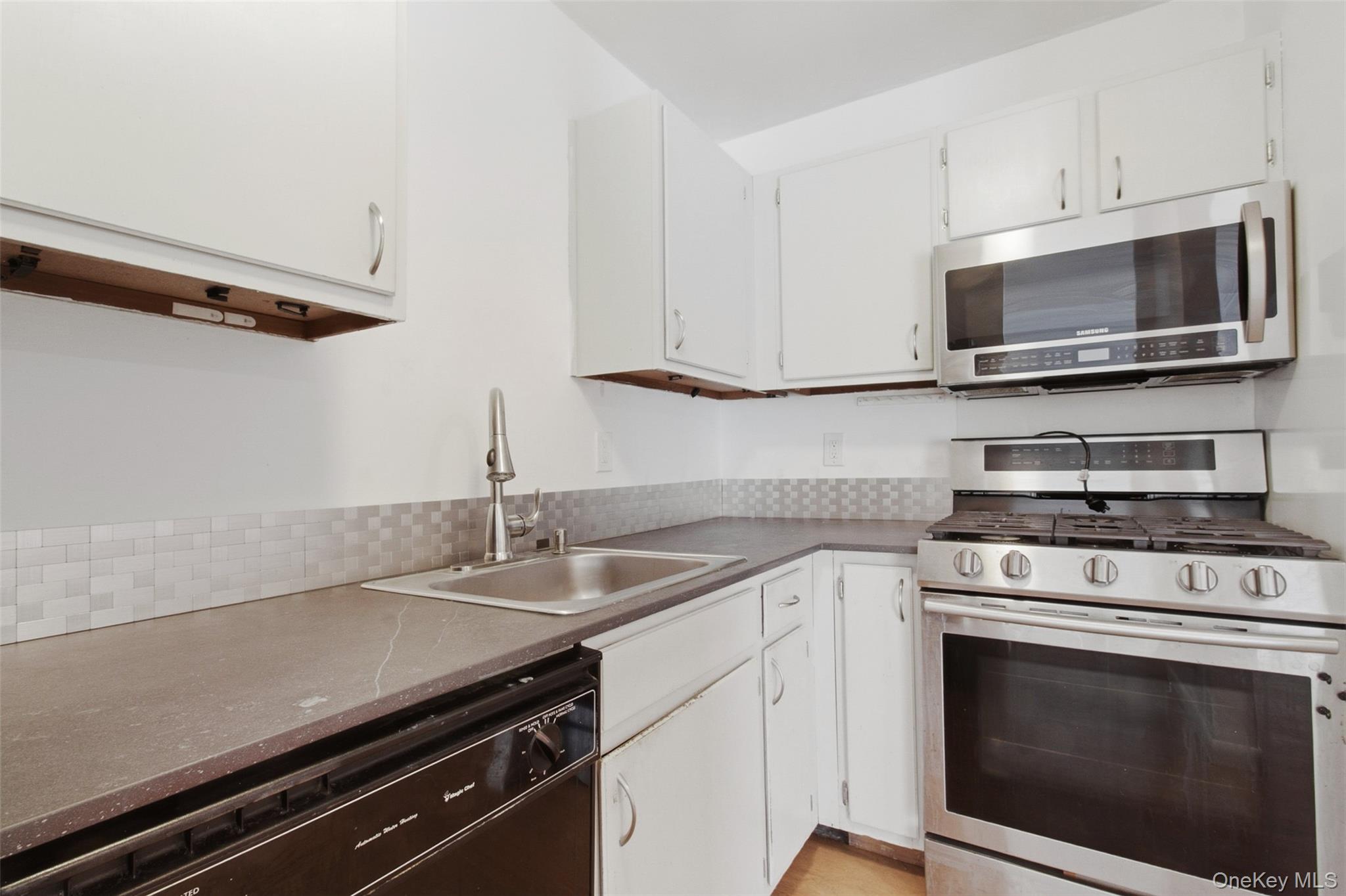 8 Ivy Court, Unit B Fishkill, NY 12524 - Photo 13 of 21 a kitchen with stainless steel appliances a stove microwave and sink