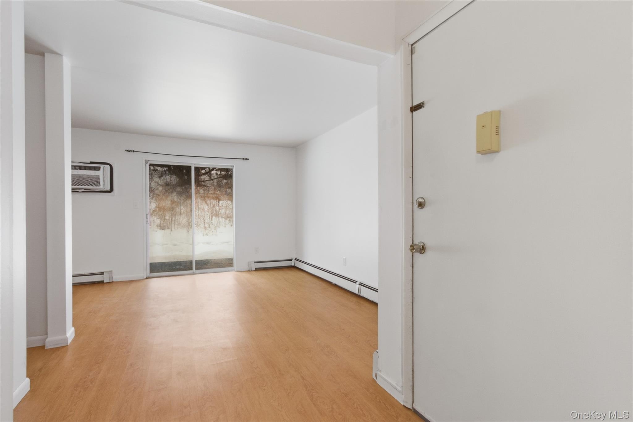 8 Ivy Court, Unit B Fishkill, NY 12524 - Photo 15 of 21 a view of an empty room with wooden floor and a window