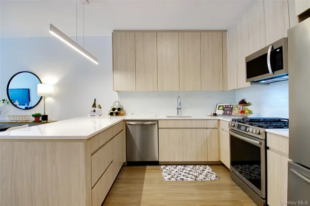 a kitchen with a sink a stove and cabinets