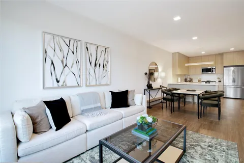 a living room with furniture kitchen view and a table