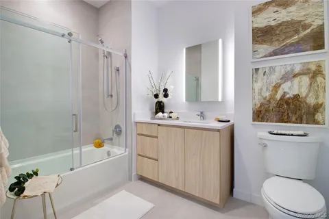 a bathroom with a sink a toilet a bathtub and shower