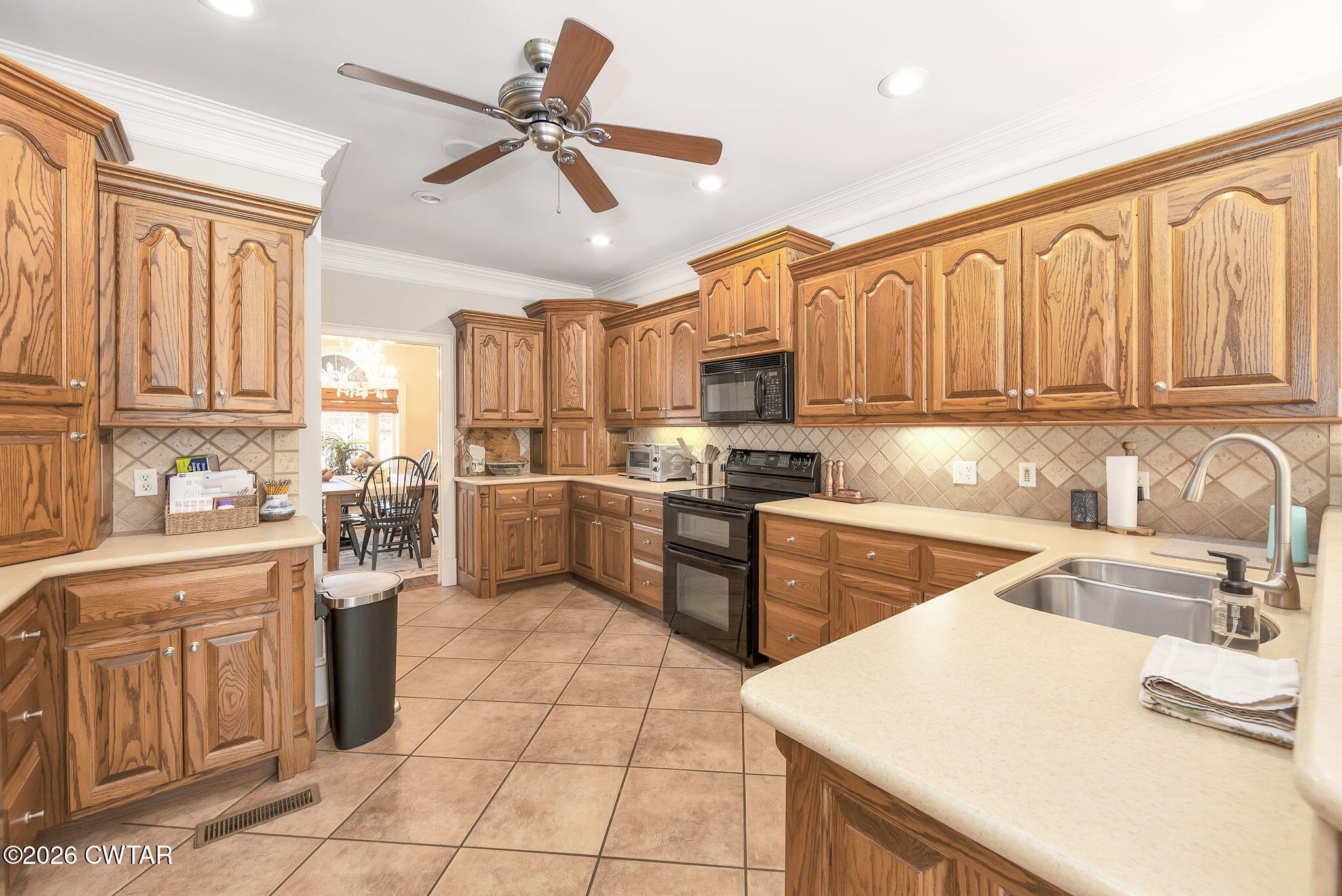 4320 Timberlake-Wildersville Road Lexington, TN 38351 - Photo 10 of 58 a kitchen with granite countertop a sink stainless steel appliances and cabinets