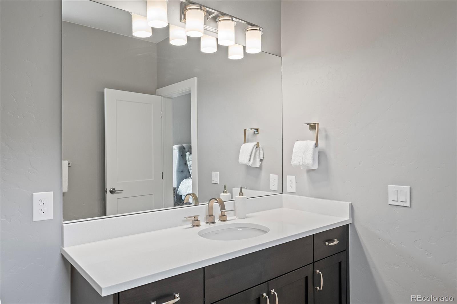 116 River Run Circle Fraser, CO 80442 - Photo 12 of 29 a bathroom with a sink a mirror and vanity