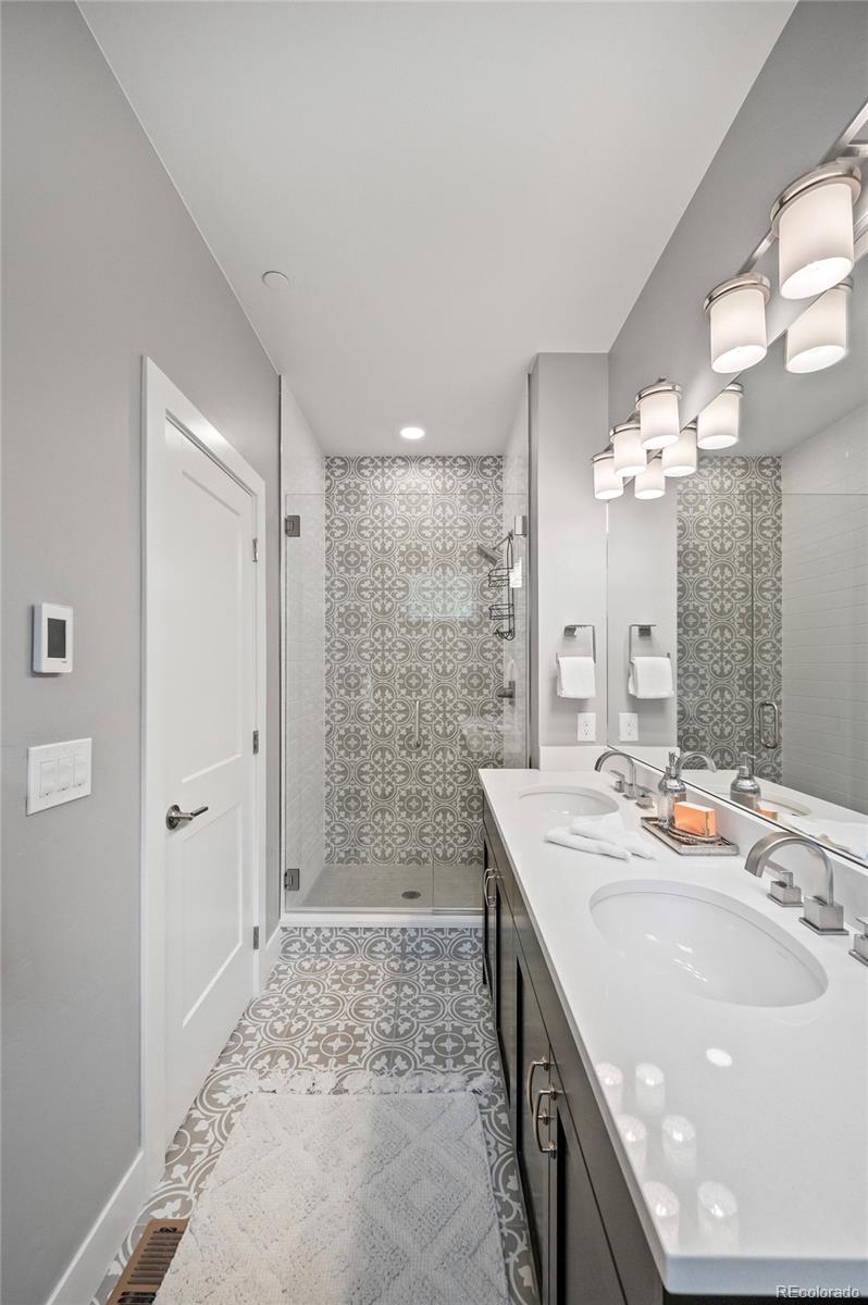 116 River Run Circle Fraser, CO 80442 - Photo 22 of 29 a spacious bathroom with a sink a shower and a mirror