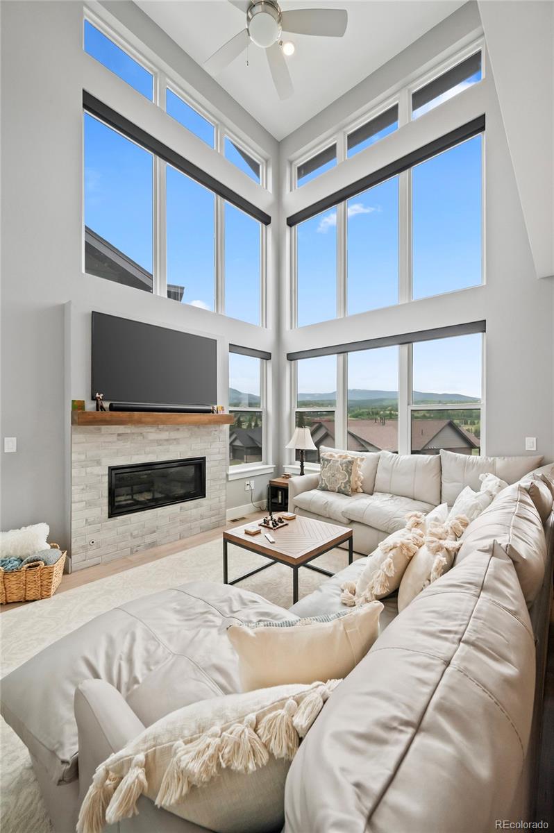 116 River Run Circle Fraser, CO 80442 - Photo 25 of 29 a living room with furniture a large window and a fireplace