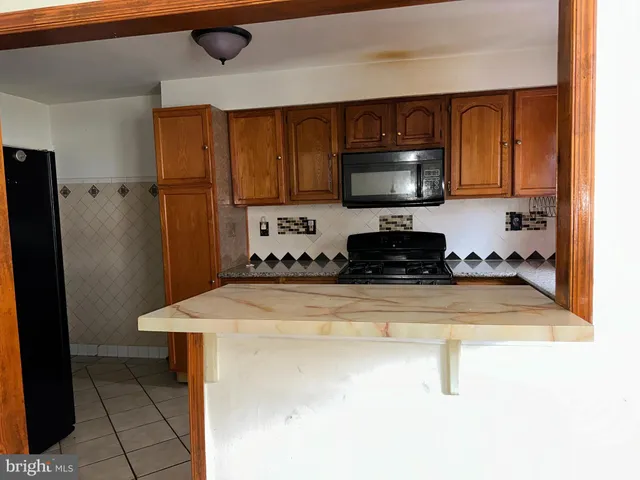 a kitchen with a sink a stove and a refrigerator