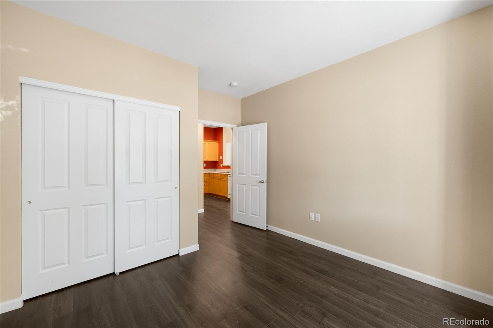 4064 South Carson Street, Unit 101 Aurora, CO 80014 - Photo 13 of 19 a view of an empty room with wooden floor