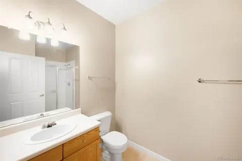 a bathroom with a sink a toilet a light fixture and mirror