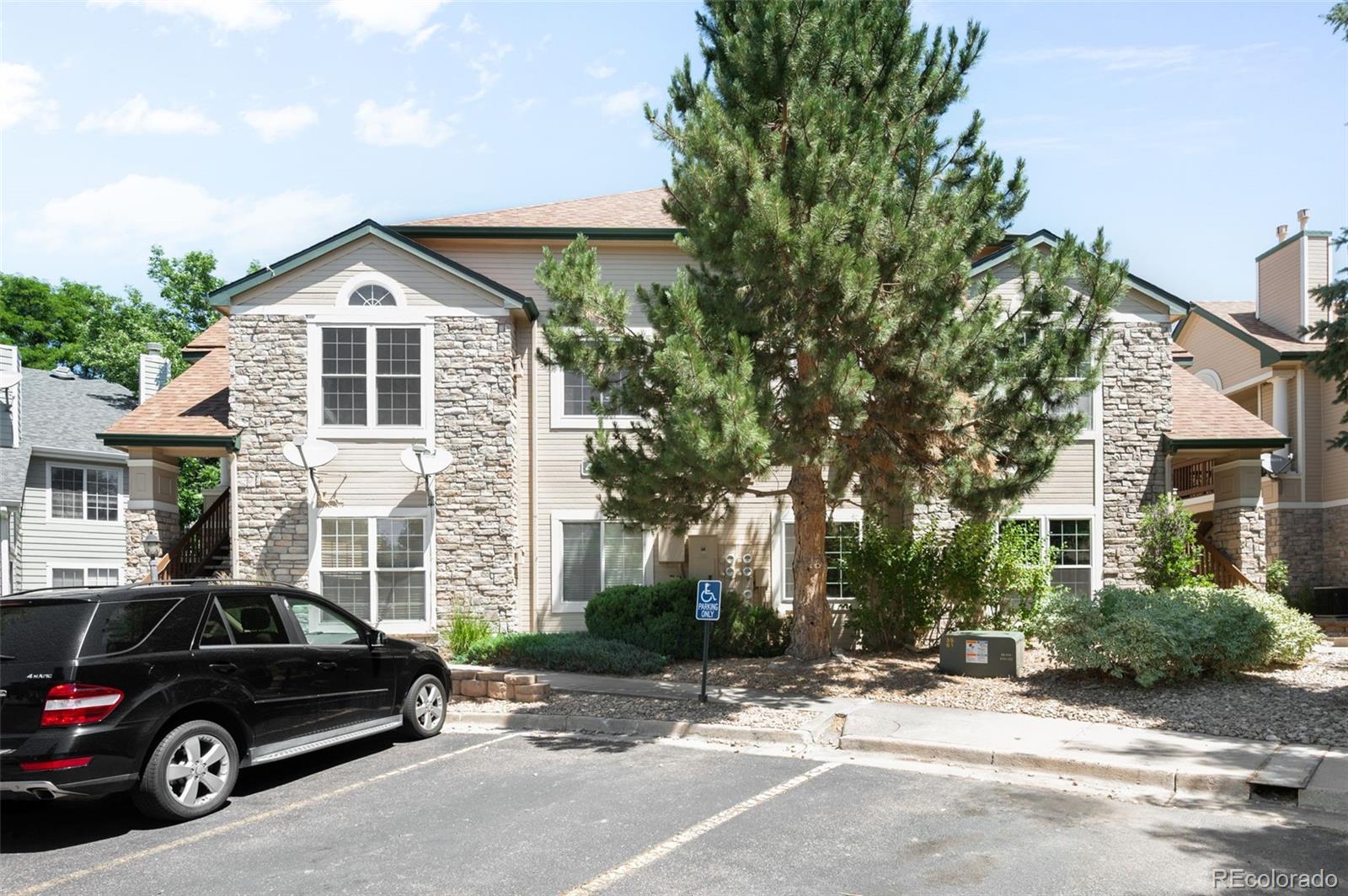 4064 South Carson Street, Unit 101 Aurora, CO 80014 - Photo 19 of 19 a view of a car parked in front of a house