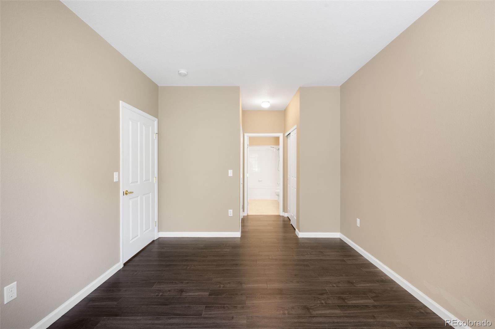 4064 South Carson Street, Unit 101 Aurora, CO 80014 - Photo 10 of 19 a view of an empty room with wooden floor