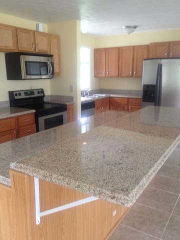 1000 North 3rd Street Rochelle, IL 61068 - Photo 8 of 14 a kitchen with stainless steel appliances granite countertop a stove a sink and a microwave