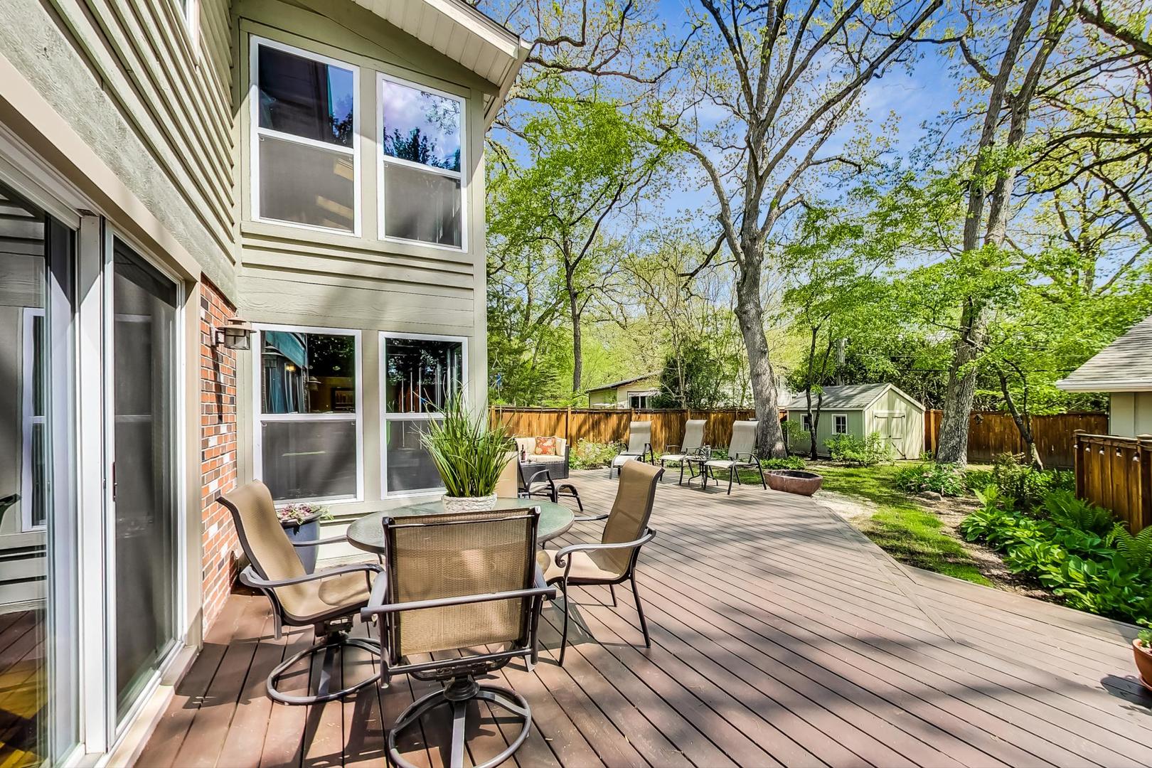 305 Dunbar Road Mundelein, IL 60060 - Photo 36 of 44 a view of a patio with table and chairs and potted plants with wooden floor and fence