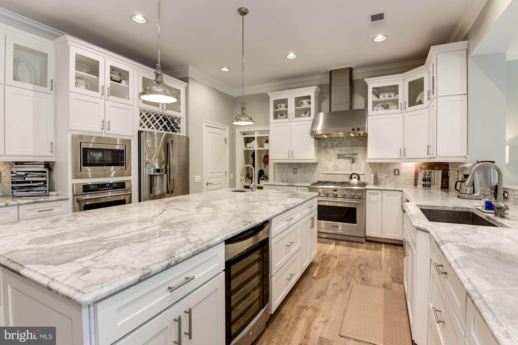 11645 Pine Tree Drive Fairfax, VA 22033 - Photo 13 of 48 a kitchen with stainless steel appliances granite countertop a stove top oven a sink dishwasher and a refrigerator with wooden floor