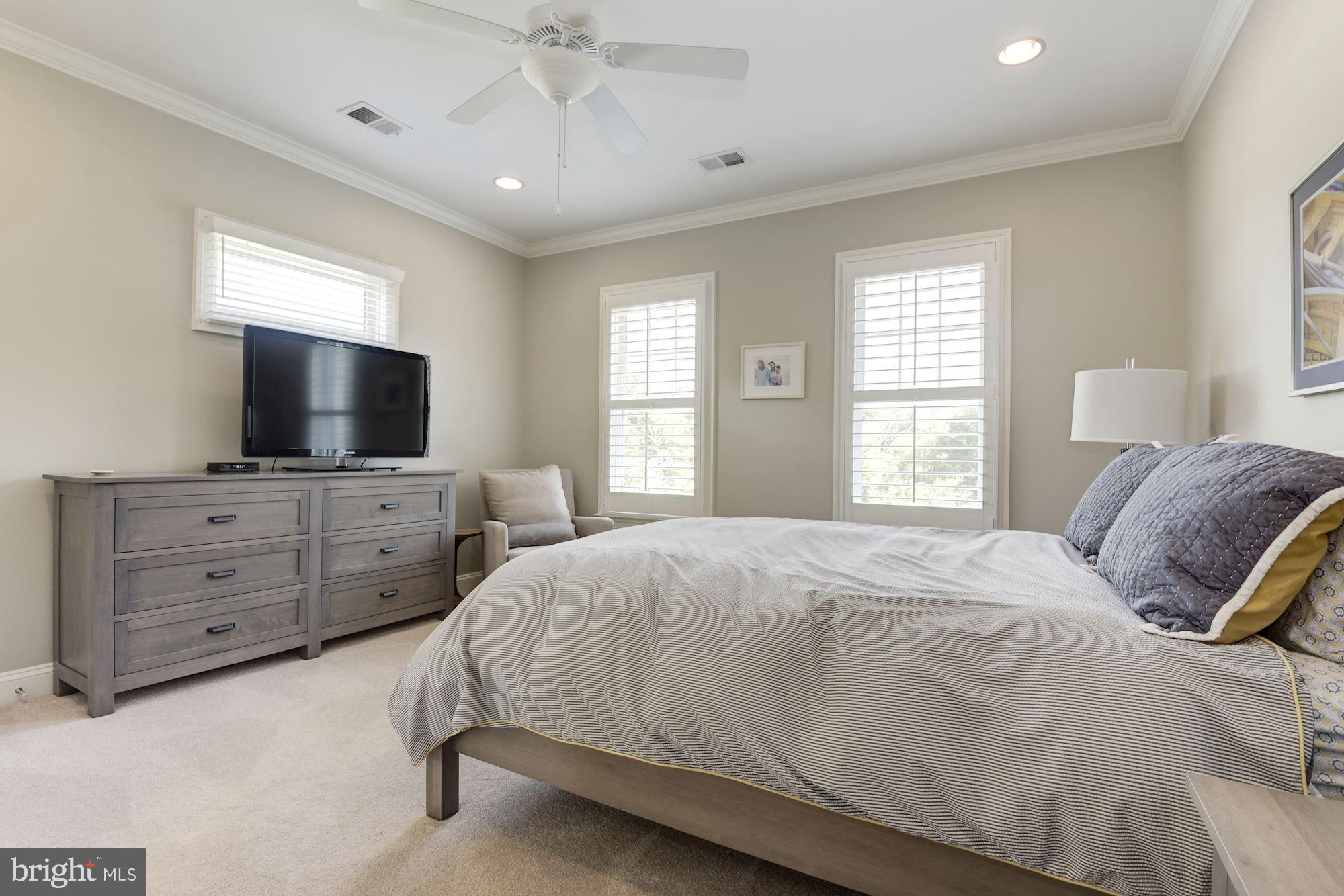 11645 Pine Tree Drive Fairfax, VA 22033 - Photo 28 of 48 a bedroom with a large bed and a flat tv screen on dresser