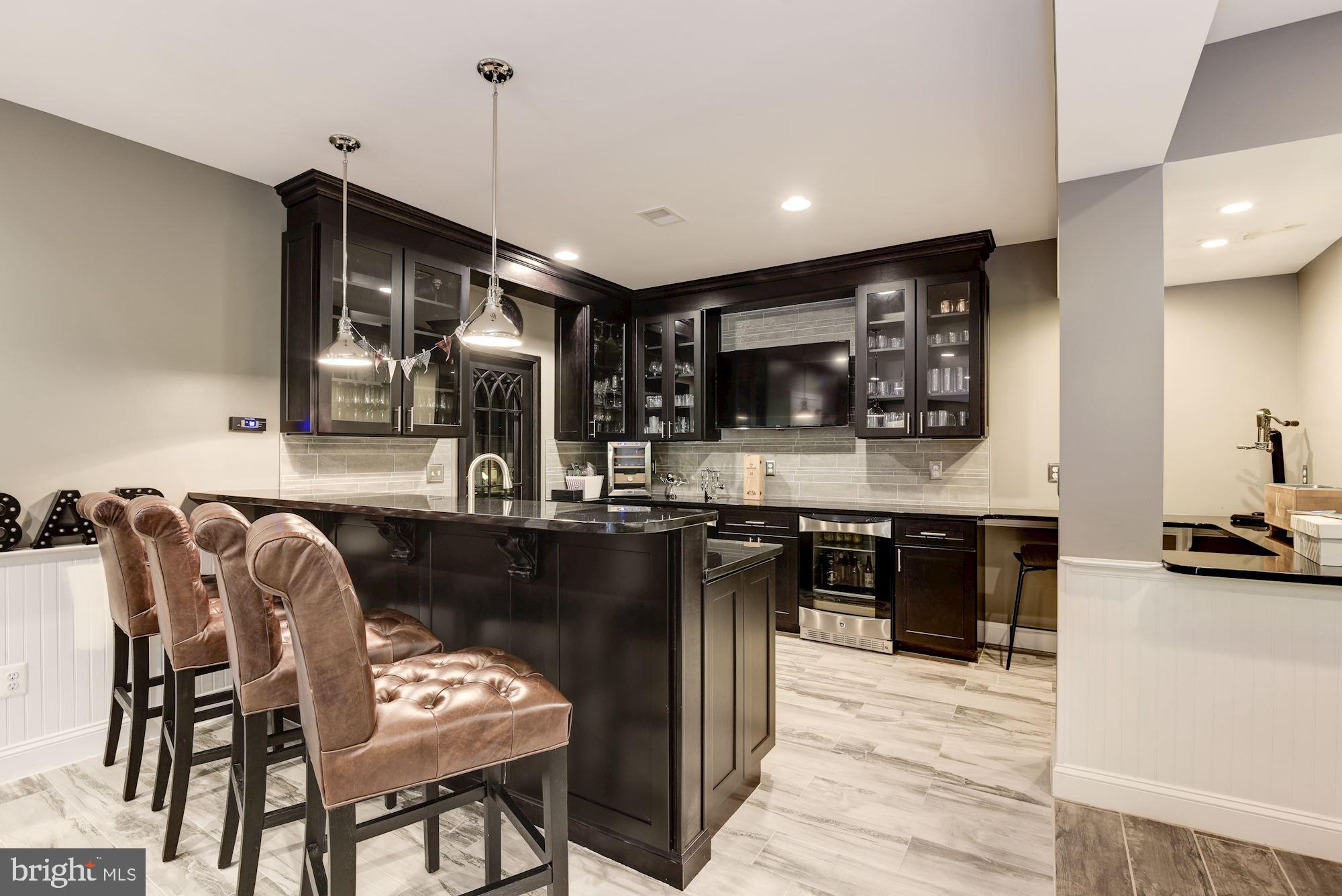 11645 Pine Tree Drive Fairfax, VA 22033 - Photo 33 of 48 a kitchen with stainless steel appliances kitchen island granite countertop a stove top oven a sink a dining table and chairs with wooden floor