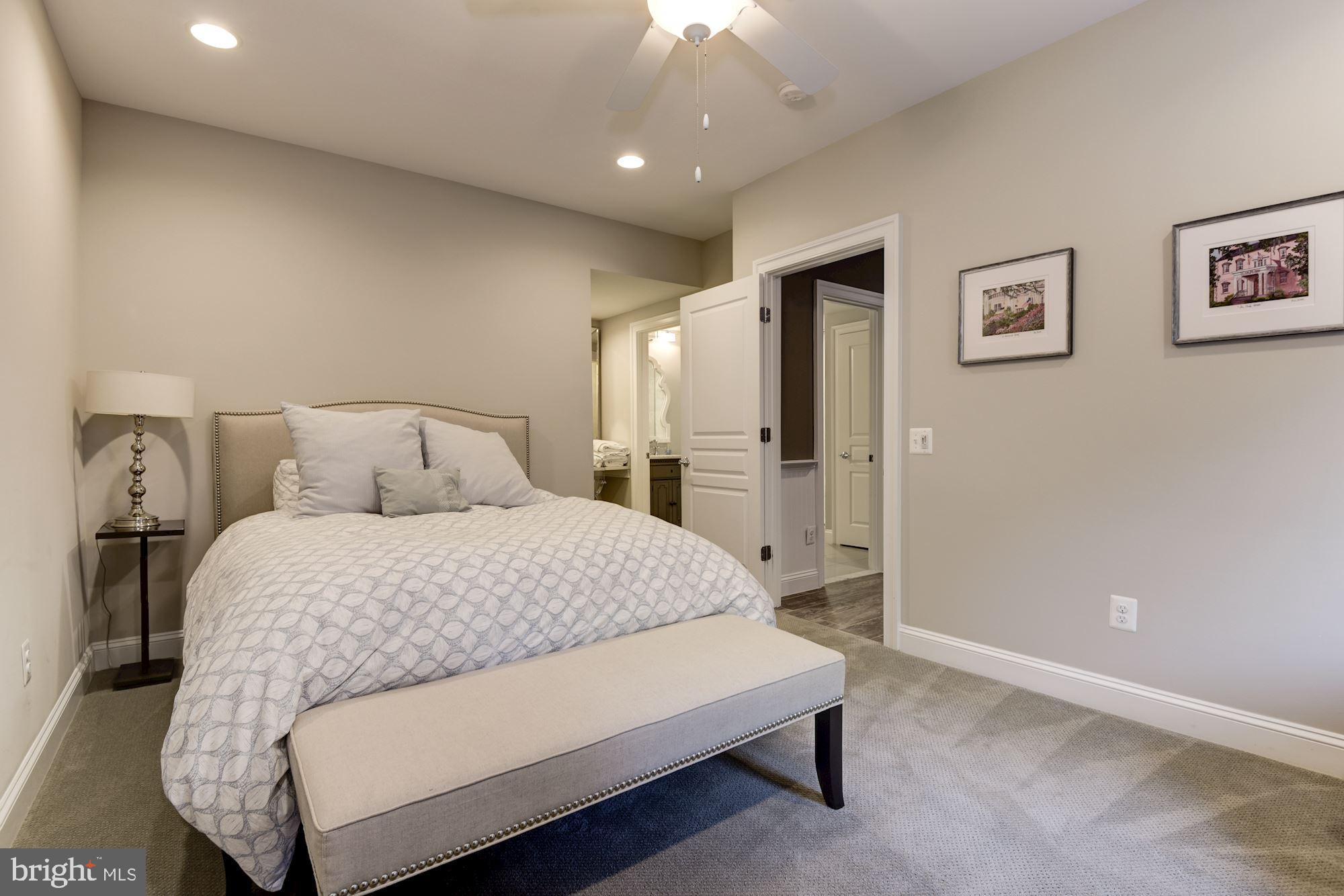 11645 Pine Tree Drive Fairfax, VA 22033 - Photo 34 of 48 a bedroom with a large bed and a chandelier