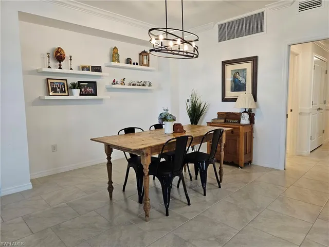 a view of a dining room with furniture and chandelier