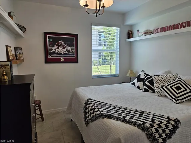 a bedroom with bed and a window