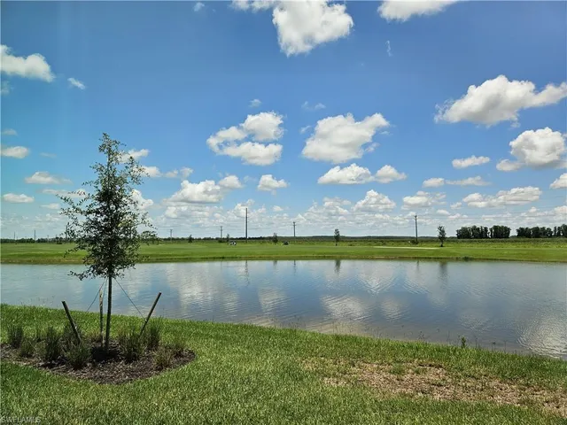 a view of a lake with houses in the back