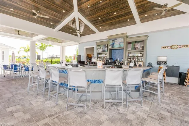 a room with stainless steel appliances kitchen island granite countertop furniture and a view of kitchen