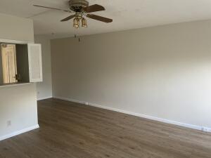 105 Mansfield F, Unit C Boca Raton, FL 33434 - Photo 2 of 14 a view of a room with wooden floor and chandelier