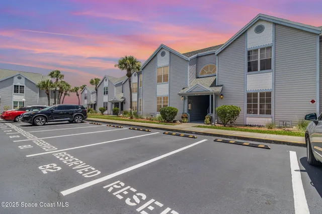 a view of a house with a pool and a car parked on the road