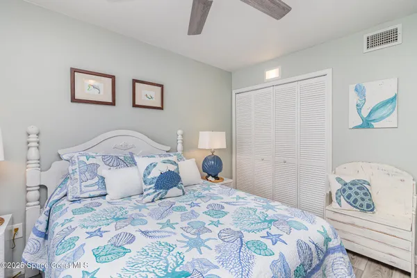 a bedroom with a bed and a lamp on dresser