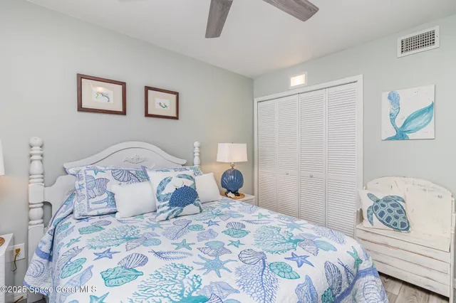 a bedroom with a bed and a lamp on dresser