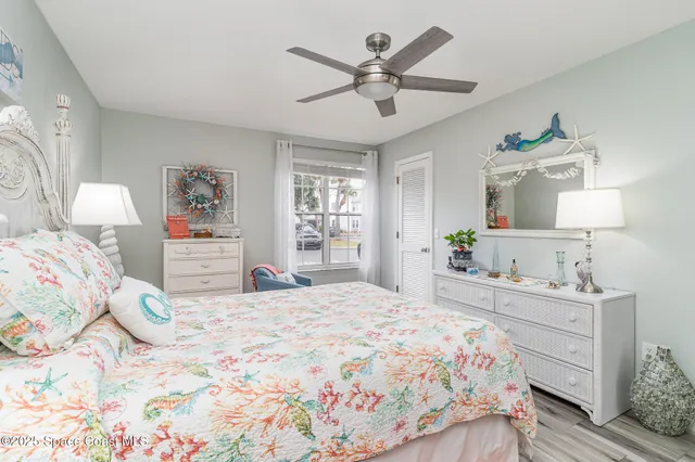 a bedroom with a bed and a lamp on dresser