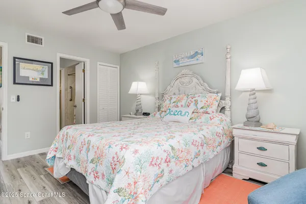 a bathroom with a granite countertop double vanity sink and a mirror