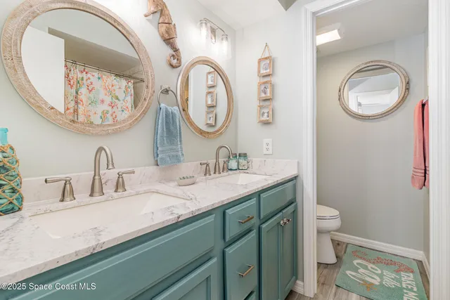 a bathroom with a shower curtain and a sink