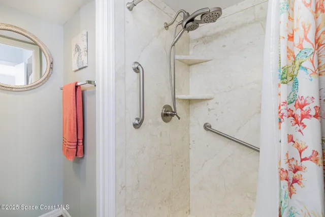 a bathroom with a granite countertop double vanity sink and a mirror