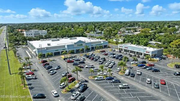 a view of swimming pool with outdoor seating and city view