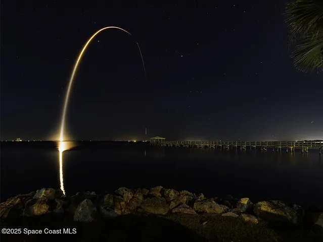a view of an empty room and wooden floor