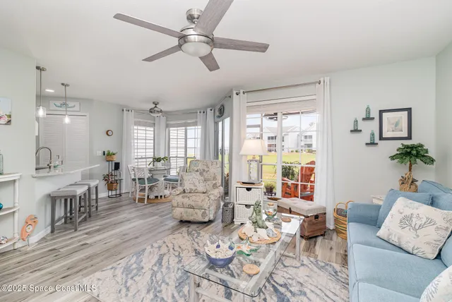 a living room with furniture couches and a large window