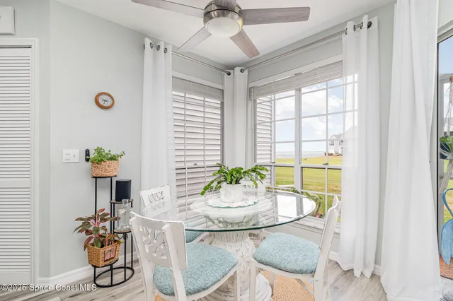 a dining room with furniture a chandelier and wooden floor