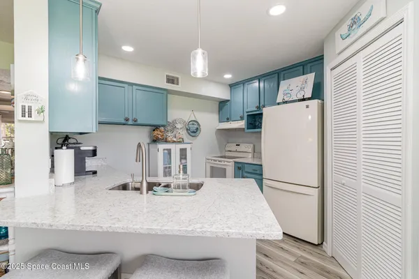 a kitchen with refrigerator and cabinets