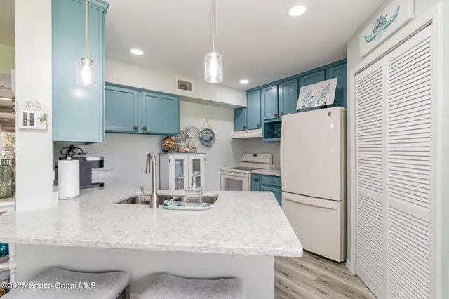 a kitchen with refrigerator and cabinets