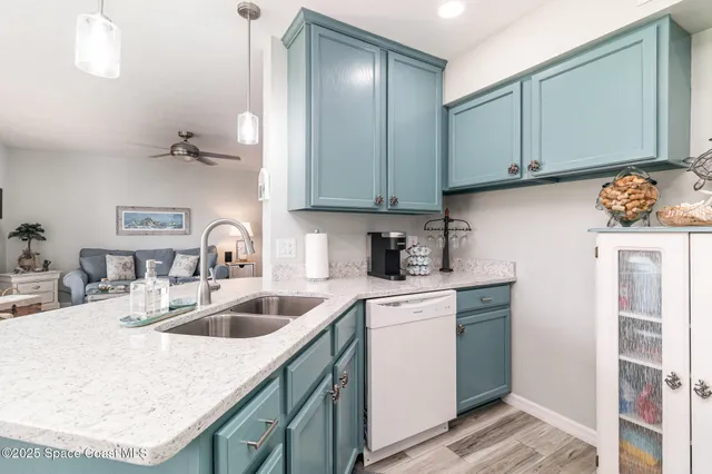 a kitchen with a sink cabinets and appliances