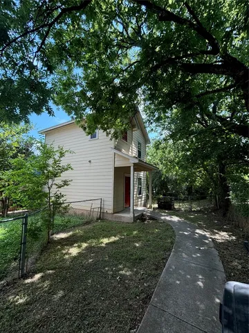 a backyard of a house with table and chairs