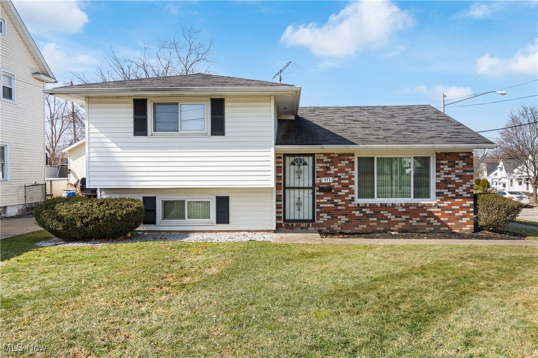 447 Center Road Bedford, OH 44146 - Photo 1 of 33 Tri-level home featuring a shingled roof, brick siding, and a front lawn