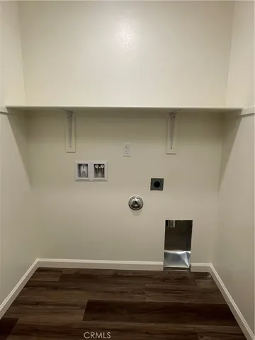a view of room with hardwood floor and cabinet