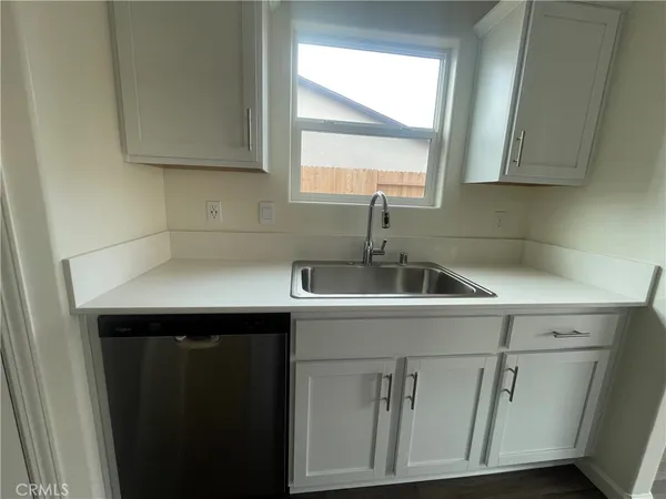 a kitchen with a sink cabinets and window