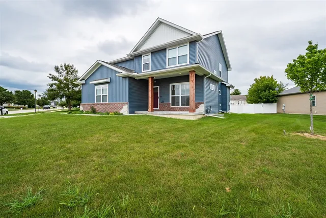 a front view of house with yard and green space